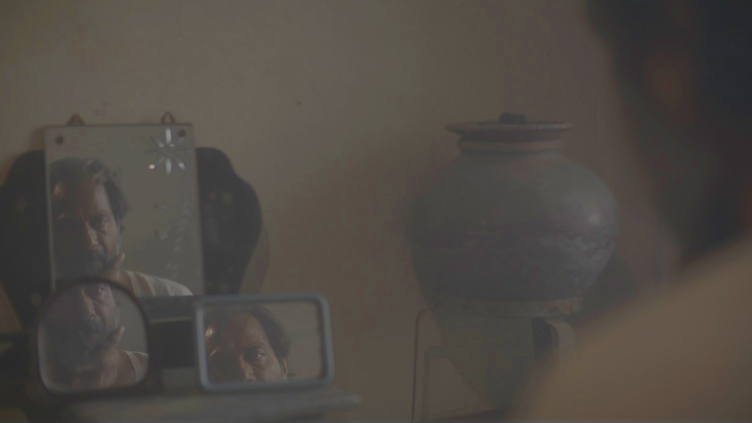 Another Short Film About Killing still, man reflected in mirrors