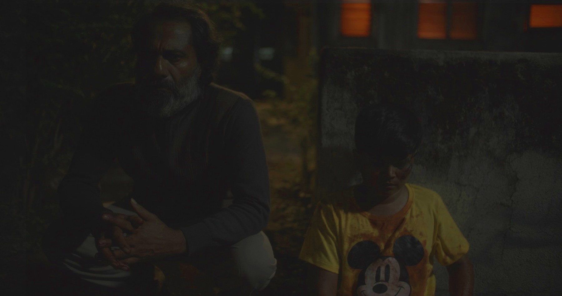 Man and child at night, still from Another Short Film About Killing