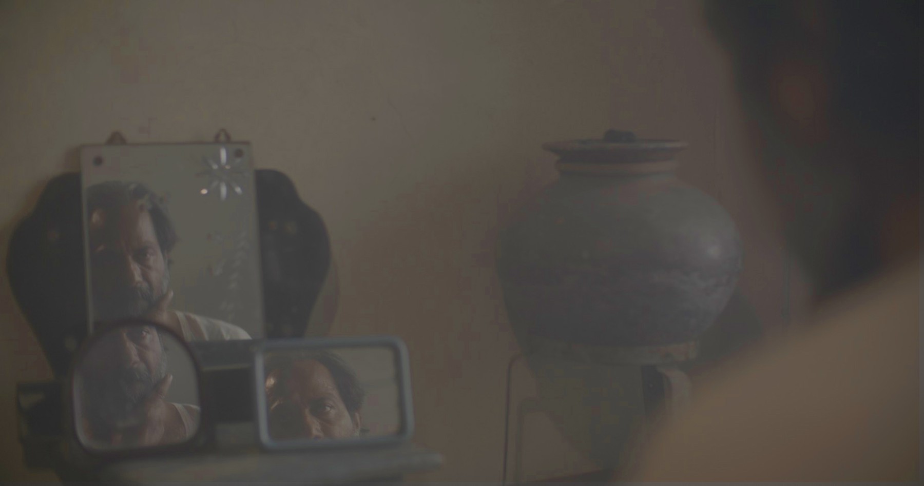 Fragmented mirror reflection, still from Another Short Film About Killing