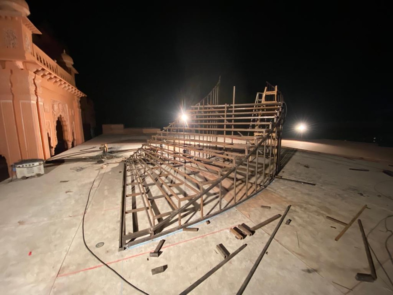 Structure under construction beside the fort at night