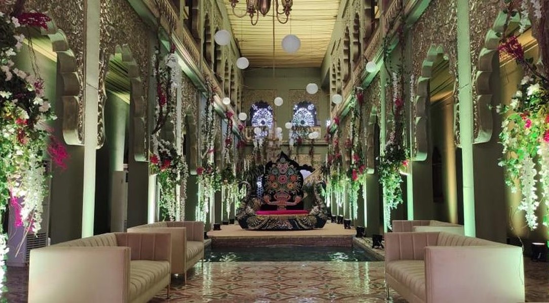 Green-lit hall with floral installation