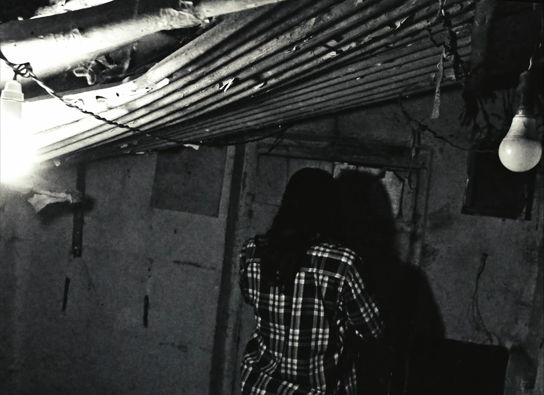 Two figures in a doorway, still from Paychecks