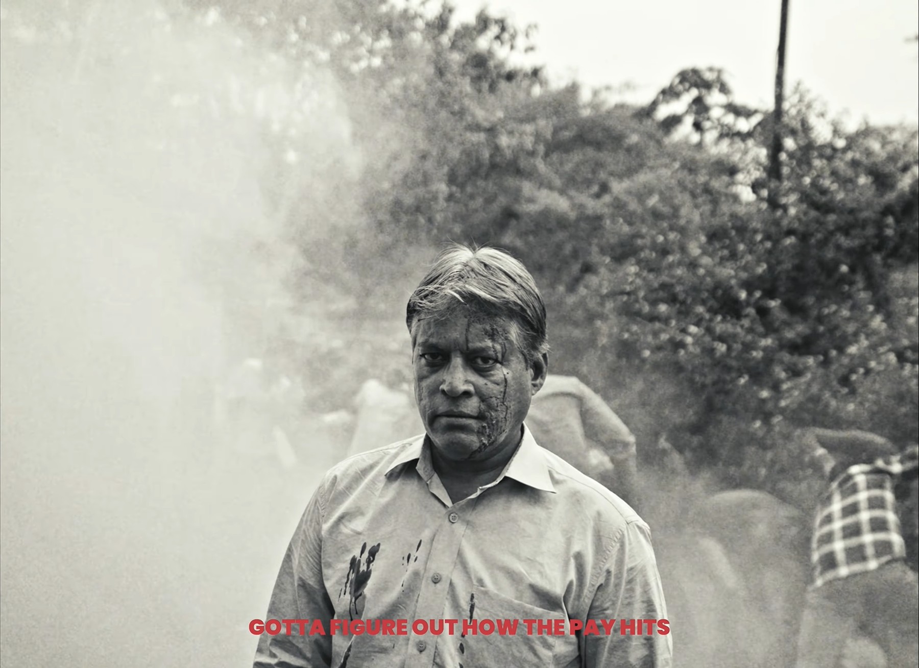 Man's bloodied face in dust, still from Paychecks