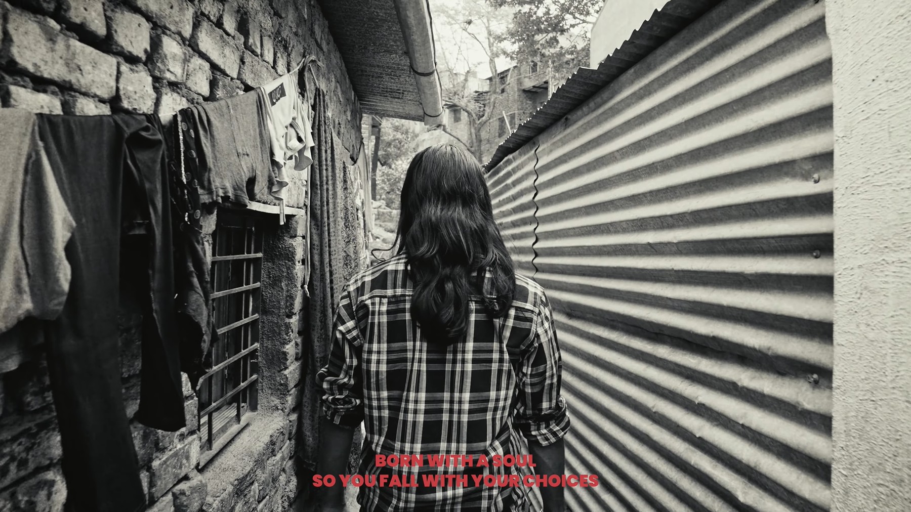 Woman walking away down a narrow alley, still from Paychecks