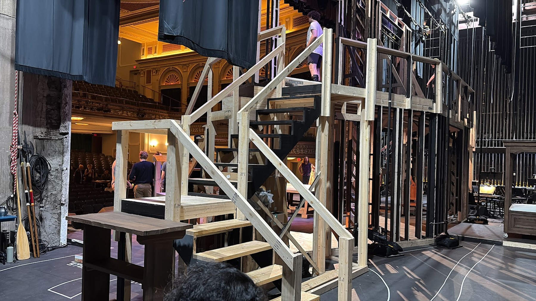 Wooden staircase and platform framing under construction on stage