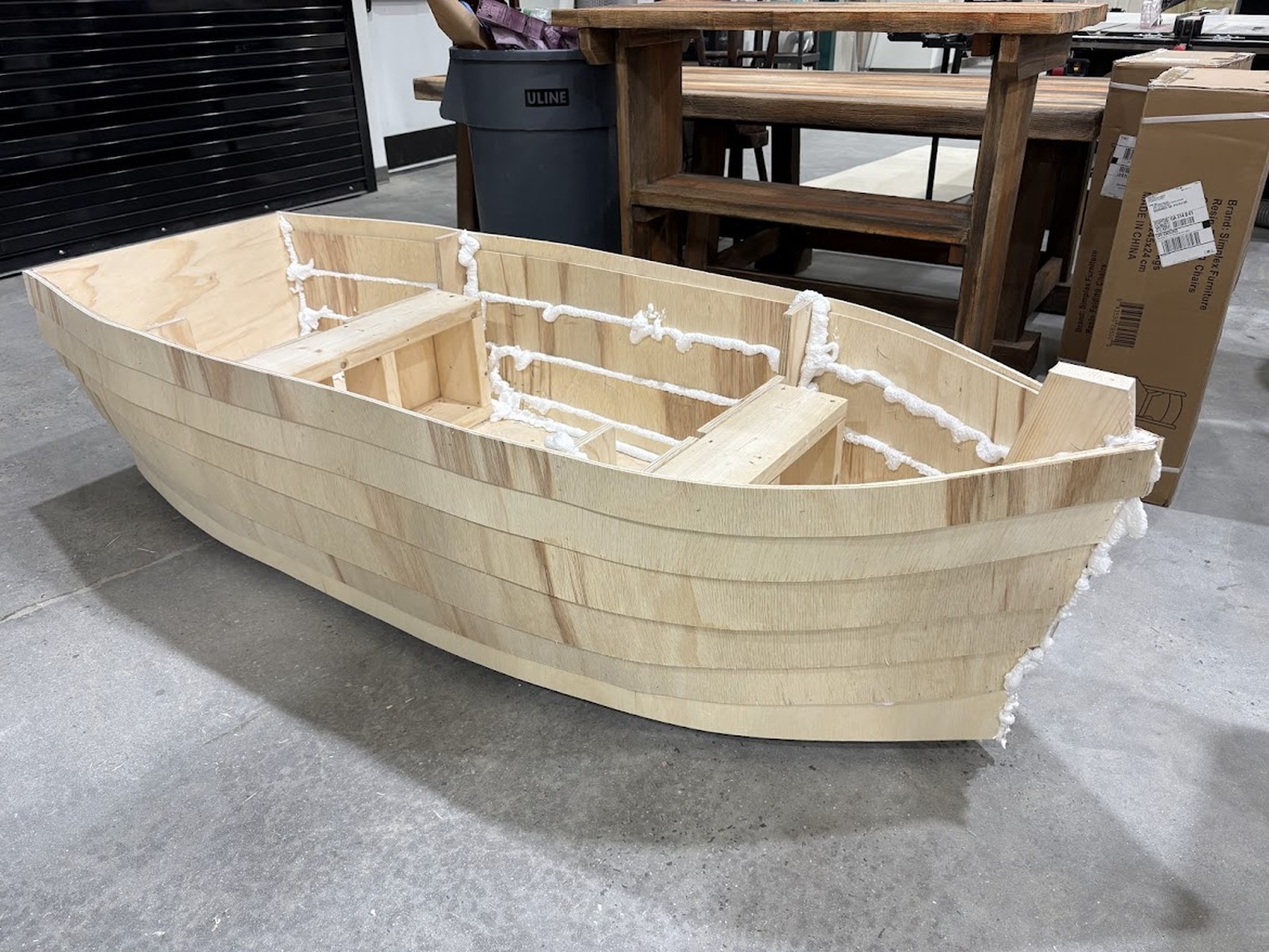 Plywood rowboat hull under construction in the shop