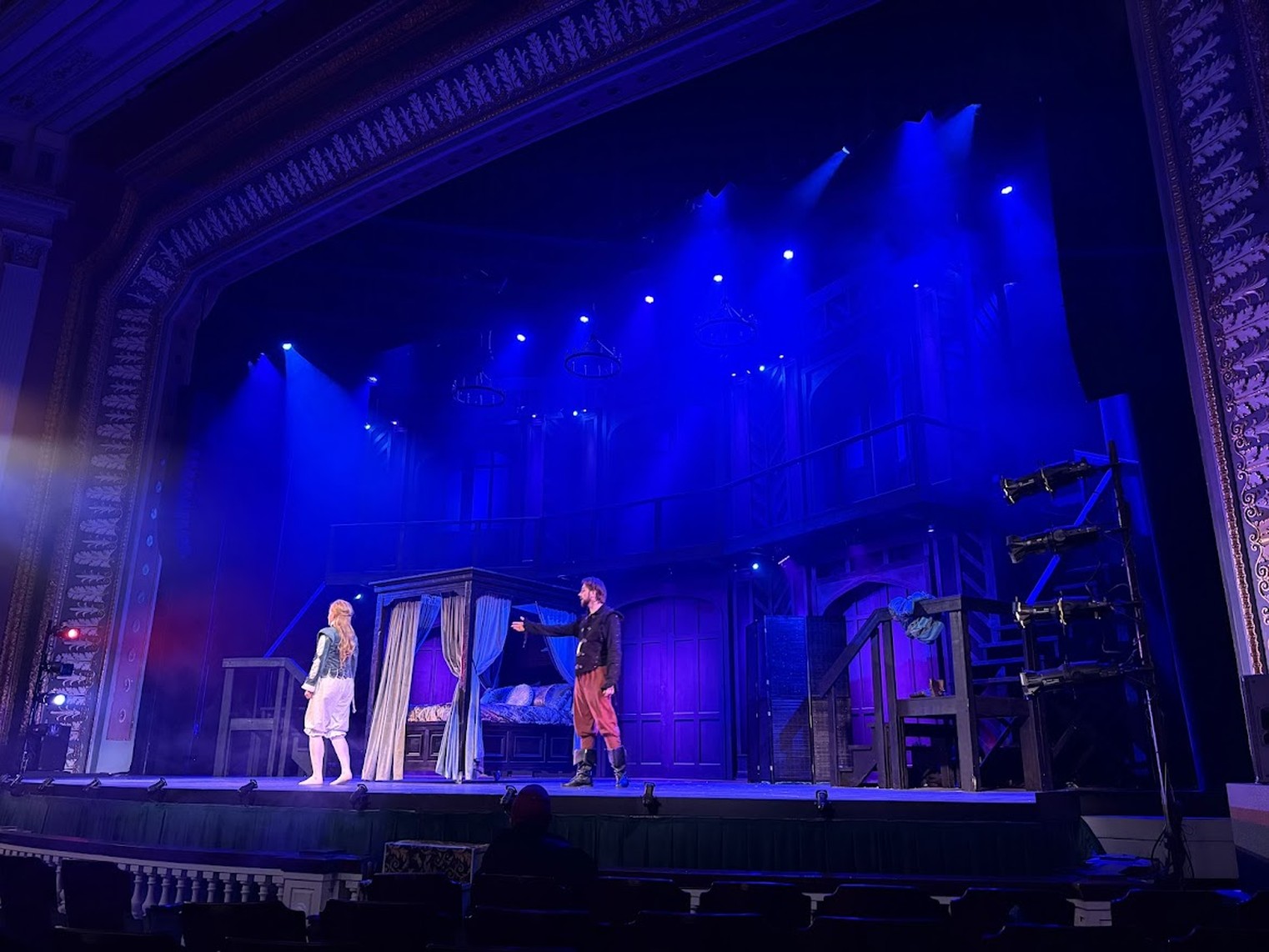 Two actors on stage beside a curtained bed, Shakespeare in Love