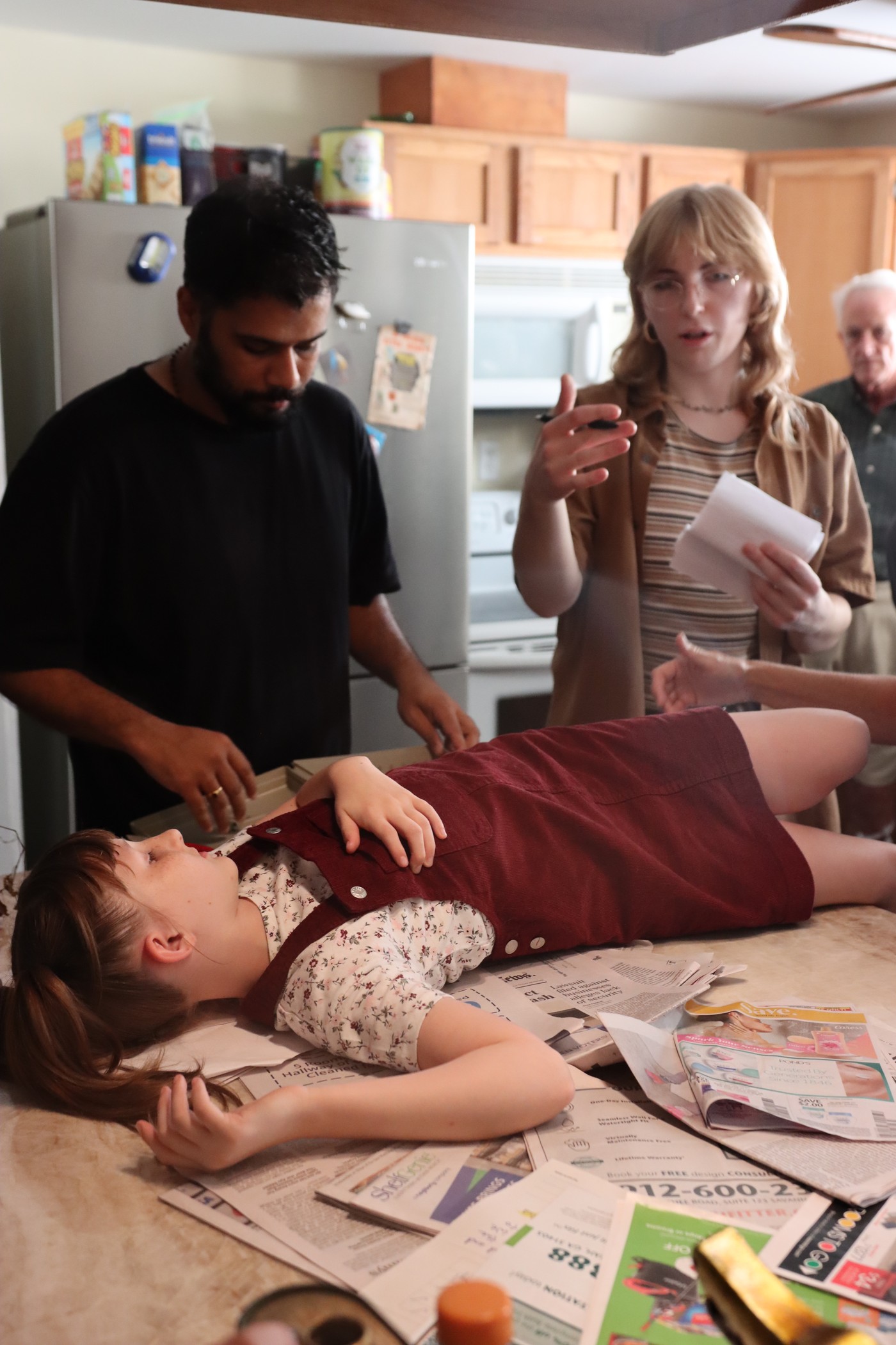 Crew dressing the set around a prop body